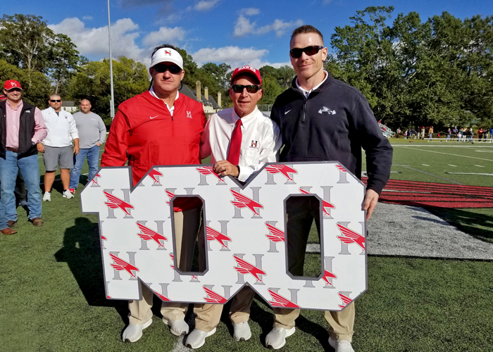 Head coach Mike Turk (center) and assistant coaches Steven Hicks (left) and Charlie Goodyear (right) were recognized after Huntingdon won its 100th game. The three have been a part of every win in program history.