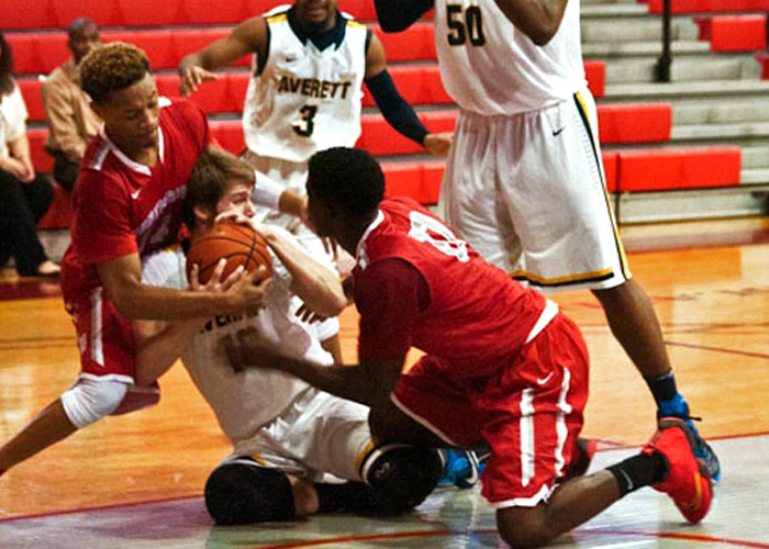 Raheem Berry (left) and Andre Ashley (right) battle Averett for control of the ball in Huntingdon's 70-67 loss on Sunday.