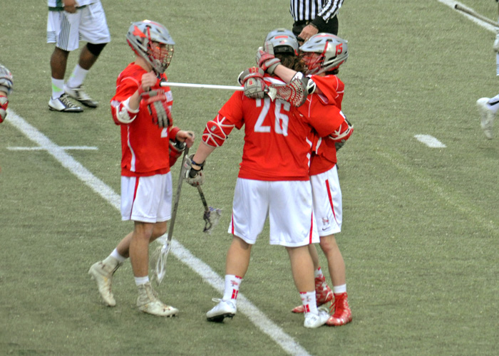 Brandon Scheele (#26) is congratulated after scoring the winning goal in Thursday's 12-11 overtime win against Greensboro. Scheele finished with three goals and an assist. (Photo by Sydney Robbins)