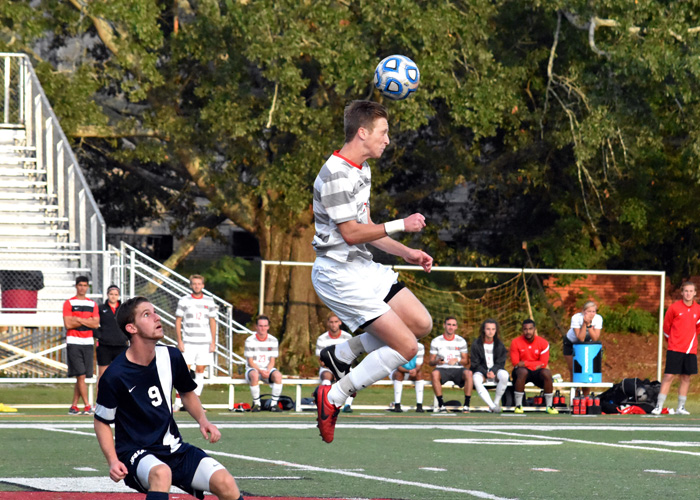 Cam Smith heads the ball away from an Averett player in Saturday's 1-0 loss to the Cougars. (Photo by Wesley Lyle)
