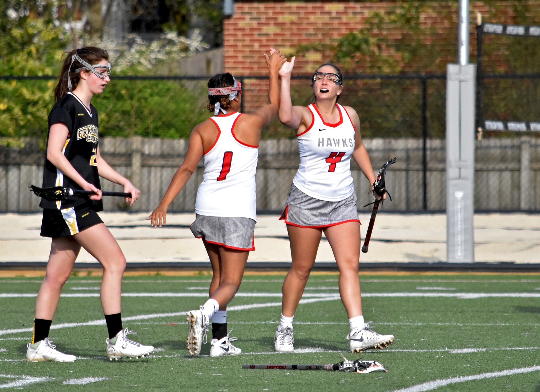 Huntingdon's Jade Paul (#1) is congratulated by Carolyn Smith (#4) after Paul's second goal in Thursday's loss to Framingham State. (Photo by Wesley Lyle)