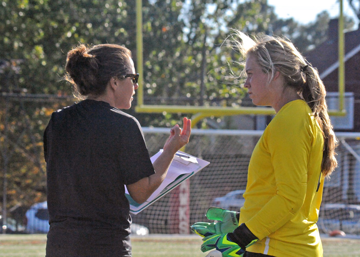 Emily Barber, shown here giving instruction to keeper Katie Bonner during the Piedmont game, was officially named the Lady Hawks' head coach on Thursday.