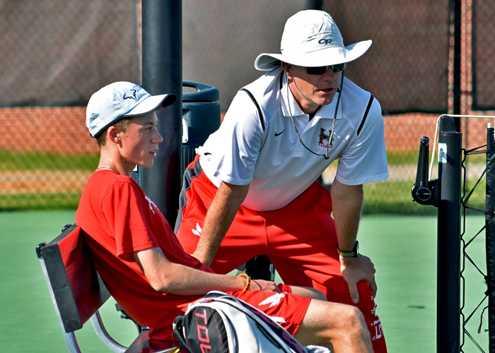 Head coach Charlie Osten talks to Adam Self during a match earlier this season. (Photo by Wesley Lyle)