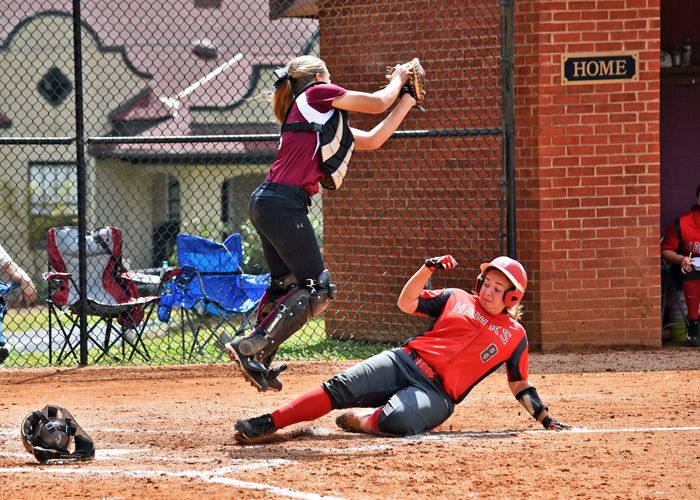 Brandi Blair slides in safely at home in Game 1 of Saturday's doubleheader with Meredith.